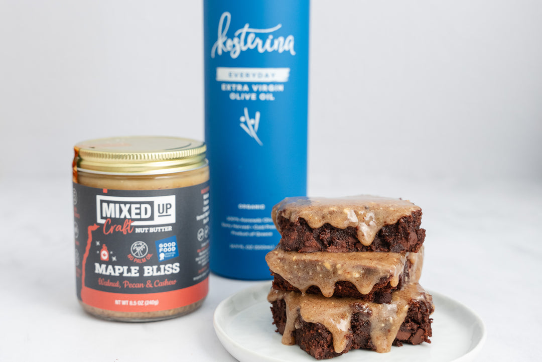 stack of brownies with jar of nut butter and olive oil